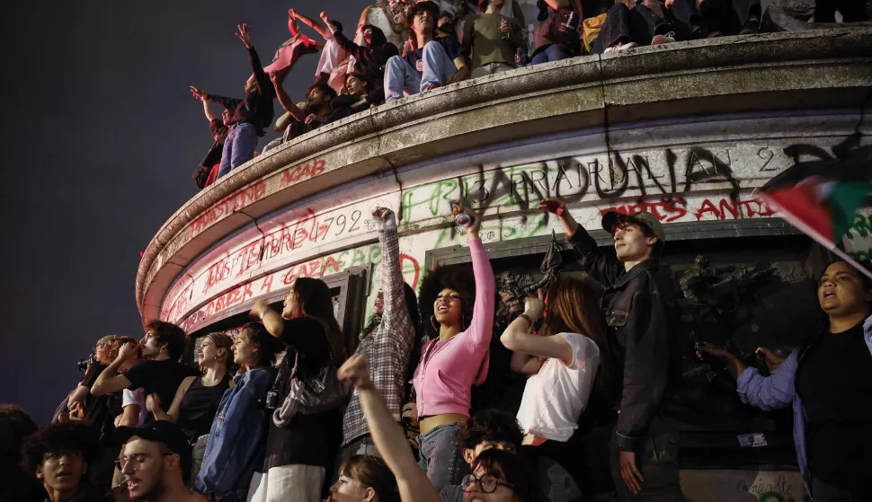 epa11466079 People react after the second round of the French legislative elections results at Place de la Republique in Paris, France, 07 July 2024. France voted in the second round of the legislative elections on 07 July. According to the first official results, the left-wing New Popular Front (Nouveau Front populaire, NFP) was ahead of President Macron's party and Le Pen's far-right National Rally (RN). EPA/YOAN VALAT