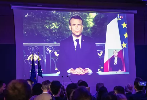 epaselect epa11400832 Supporters of presidential party RE Renaissance watch French President Emmanuel Macron's speech displayed on the screen at the electoral party after the announcement of the results in Paris, France, 09 June 2024, after the first results of the European Elections. The list of the Rassemblement National, led by party chief Jordan Bardella, is given winner in France, according to first estimations after polls. Macron called for a snap legislative election after the defeat in the EU votes. EPA/CHRISTOPHE PETIT TESSON