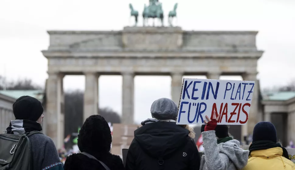 epa11076294 A protester holds a placard reading 'No place for Nazis' during a demonstration against the far-right Alternative for Germany (AfD) party in front of the Brandenburg Gate in Berlin, Germany, 14 January 2024. The protest held under the slogan 'Defend Democracy', was organized by the Fridays for Future movement, along with other non-governmental organizations, as a reaction to revelations of the investigative journalism group Correctiv, and their report about a meeting of far-right politicians, who allegedly discussed deportation plans referred to as 'remigration', a term promoting the forced return of 'migrants' to their place of origin. EPA/CLEMENS BILAN