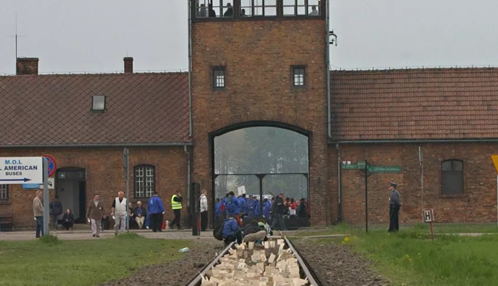 People place memory plaques on rails in Birkenau during the annual March of the Living at the former Nazi Death Camp Auschwitz-Birkenau, in Oswiecim, southern Poland, May 1, 2008, to commemorate Holocaust victims. (AP Photo/Alik Keplicz)