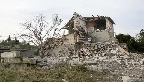 epa11486988 People walk at the site of Russian rocket strike in the city of Chuhuiv in the Kharkiv region, northeastern Ukraine, 19 July 2024. At least nine people were injured, including one child, after a Russian rocket hit Chuhuiv according to the head of the Kharkiv Military Administration Oleg Synegubov. Russian troops entered Ukrainian territory on 24 February 2022, starting a conflict that has provoked destruction and a humanitarian crisis. EPA/SERGEY KOZLOV