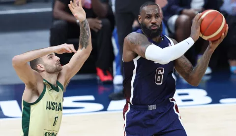 epa11480327 LeBron James (R) of the USA and Jack McVeigh of Australia in action during the 2024 USA Basketball Showcase game between USA and Australia in Abu Dhabi, United Arab Emirates, 15 July 2024. EPA/ALI HAIDER