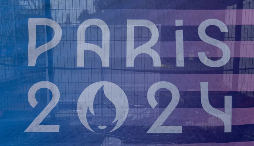 epa11474084 The logo of the Paris 2024 Olympic Games is printed on the cover of a construction site in Paris, France, 12 July 2024. The opening ceremony of the Paris 2024 Olympic Games will begin with a nautical parade on the Seine and ends on the protocol stage in front of the Eiffel Tower on 26 July 2024. EPA/ANDRE PAIN