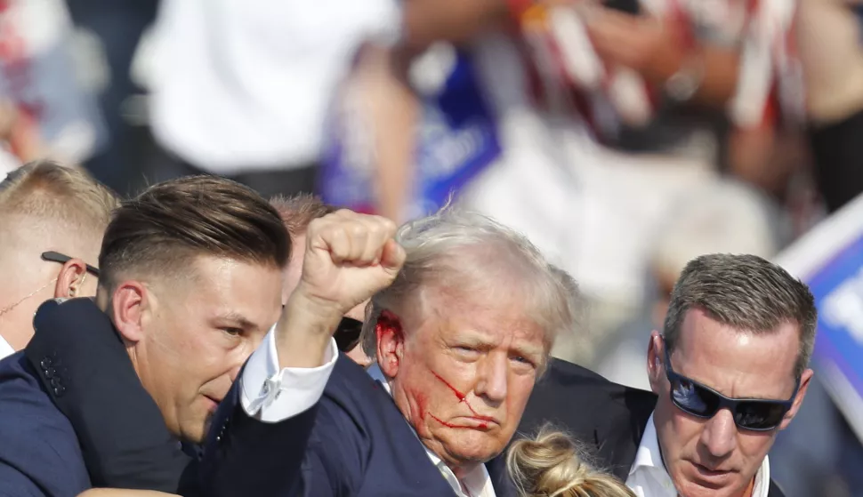 epa11476744 Former US President Donald Trump is rushed off stage by secret service after an incident during a campaign rally at the Butler Farm Show Inc. in Butler, Pennsylvania, USA, 13 July 2024. EPA/DAVID MAXWELL