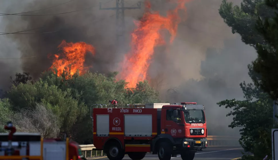 epa11457452 Firefighers douse flames caused by projectiles fired from south Lebanon, at Mevuot Hermon, upper Galilee, in northern Israel 04 July 2024. Israeli army reported that fighter jets struck Hezbollah targets in southern Lebanon, including a military structure in the area of Chihine and three terrorist infrastructure sites in the area of Blat. In addition, more than 100 launches were identified fired from Lebanon. EPA/ATEF SAFADI