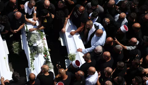 epa11501543 Relatives and friends of the families attend the funeral of ten young people killed by a rocket attack from Lebanon, in the village of Majdal Shams in the annexed Golan Heights, 28 July 2024. According to the Israel Defense Forces (IDF), a rocket launched from Lebanon toward Majdal Shams caused multiple civilian casualties, including children. Approximately 30 projectiles were identified as crossing from Lebanon, the IDF said. EPA/ATEF SAFADI