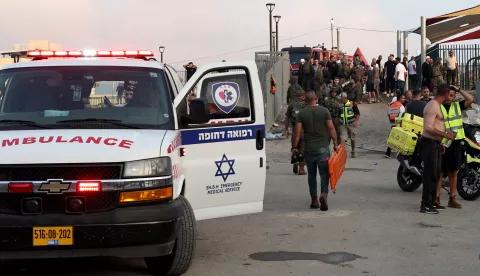 epa11500449 Soldiers, emergency services and civilians at the site where a projectile hit a playground in Druze, Majdal Shams, in the annexed Golan Heights, 27 July 2024. According to the Israel Defence Forces (IDF), a rocket launched from Lebanon toward Majdal Shams caused multiple civilian casualties, including children. Approximately 30 projectiles were identified crossing from Lebanon, the IDF said. EPA/ATEF SAFADI