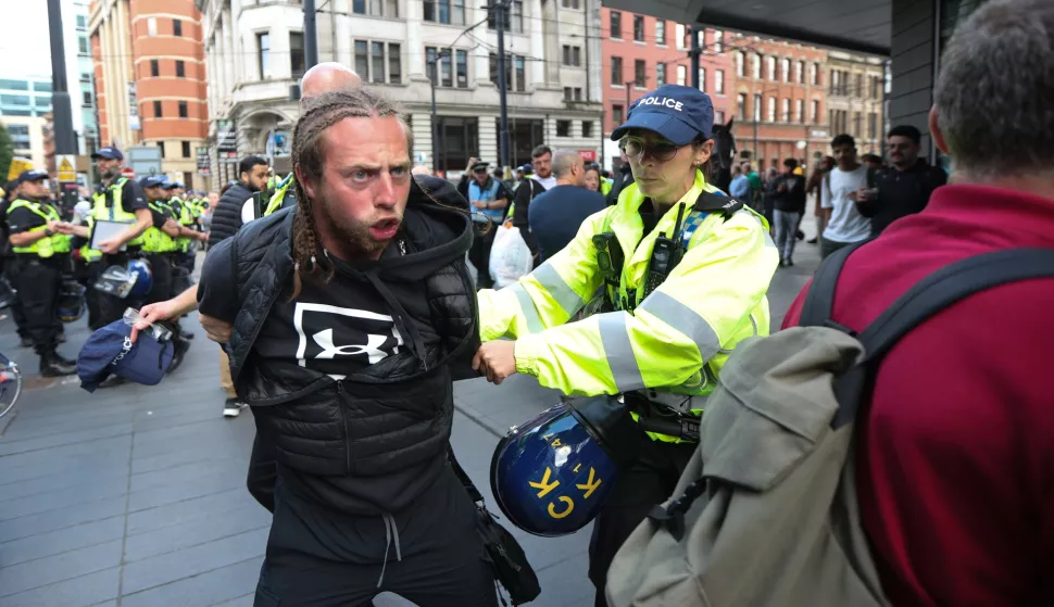 epa11521719 A protester is detained by police in Manchester, Britain, 03 August 2024. Violent demonstrations by members of far-right groups have sprung up across Britain in the aftermath of a fatal stabbing attack in Southport, in which three children were killed and eight more seriously injured along with two adults. EPA/STR