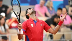 epa11520091 Novak Djokovic of Serbia gestures as he plays against Lorenzo Musetti of Italy (unseen) during their Men's singles semi final match at the Tennis competitions in the Paris 2024 Olympic Games, at the Roland Garros in Paris, France, 02 August 2024. EPA/CAROLINE BLUMBERG