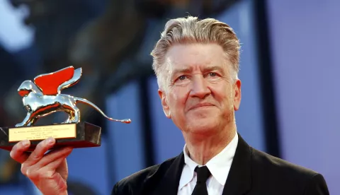  ** CORRECTS SPELLING OF LYNCH ** US director David Lynch shows the Golden Lion lifetime achievement award received at the 63rd edition of the Venice film festival in Venice, Italy, Wednesday Sept. 6, 2006.(AP Photo/Luca Bruno)
