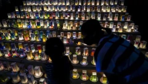epa08591531 A young girl with her mother looks at hundreds of lanterns with messages of peace at the Peace Park in Nagasaki, southern Japan, 08 August 2020. Nagasaki is preparing to mark the 75th anniversary of the 1945 atomic bombing on 09 August as related events are either canceled or scaled down this year to avoid the spreading of the coronavirus disease (COVID-19) pandemic. In 1945 the United States dropped two nuclear bombs over the cities of Hiroshima and Nagasaki on 06 and 09 August respectively, killing more than 200,000 people. EPA/DAI KUROKAWA