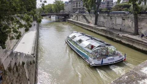 epa11524167 A tourist boat sails on the Seine River, in Paris, France, 04 August 2024. According to Paris Olympics organizers, the swimming training session scheduled on 04 August for the triathlon mixed relay event has been canceled after recent heavy rain affected water quality levels in the Seine river. It is the second consecutive day the triathlon training session is canceled. EPA/ANDRE PAIN