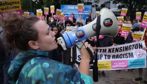 epa11534966 An anti-racist protester speaks through a megaphone in Brentford, west London, Britain, 07 August 2024. Further far-right protests are expected throughout Britain on the 07 August 2024. Violent demonstrations have been held by members of far-right groups across Britain following a fatal stabbing attack in Southport, in which three children were killed and eight more seriously injured along with two adults. EPA/NEIL HALL