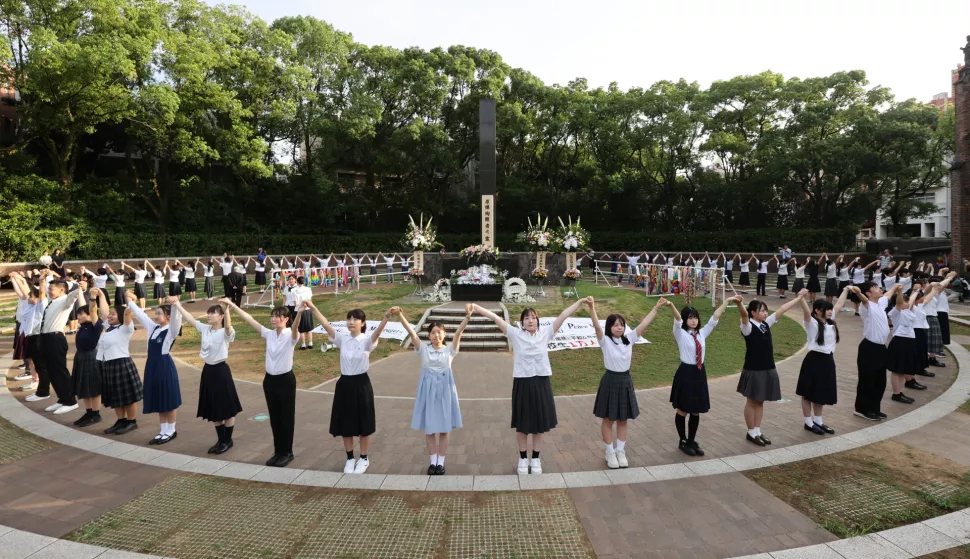 epa11538497 High school students form a human chain around the Ground Zero, Atomic Bomb Hypocenter Monument to appeal for a peaceful world during an event marking the 79th anniversary of the atomic bombing at Nagasaki Peace Park in Nagasaki, southwestern Japan, 09 August 2024. Nagasaki Mayor Shiro Suzuki reiterated on 08 August 2024 not to invite Israel for the 79th Nagasaki Peace Ceremony and announced that the ambassadors of the United States, five European countries and the EU will not attend the ceremony. Ambassadors from the United States, Britain, Canada, Germany, Italy and the EU have sent a letter to the mayor mid-July that they will not attend the peace memorial ceremony marking the 79th anniversary of the atomic bombing of Nagasaki if Israel is excluded. Nagasaki City has estimated the victims of the bombing rose to 73,884 until the end of 1945. EPA/JIJI PRESS JAPAN OUT EDITORIAL USE ONLY/