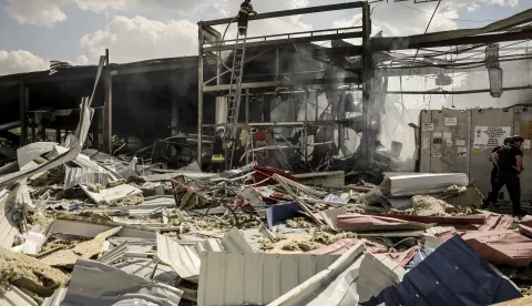 epa11539839 Ukrainian rescuers work at the site of Russian shelling on a shopping mall in Kostiantynivka, Donetsk region, Ukraine, 09 August 2024. According to the State Emergency Service of Ukraine, at least 11 people died and 44 others were injured in the shelling, while residential buildings, shops, and more than a dozen cars were damaged. EPA/STR