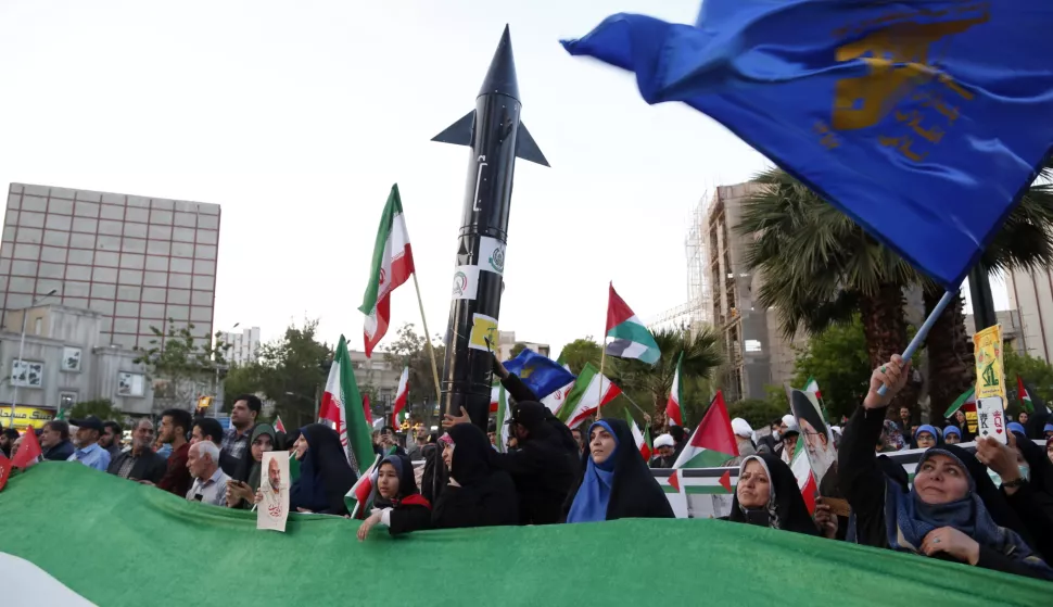 epa11280624 Iranians hold a mock missile during a celebration following Iran's attack on Israel, at the Palestine square, in Teheran, Iran, 15 April 2024. Iran's Islamic Revolutionary Guards Corps (IRGC) launched drones and rockets towards Israel late on 13 April 2024, Iranian officials said. EPA/ABEDIN TAHERKENAREH