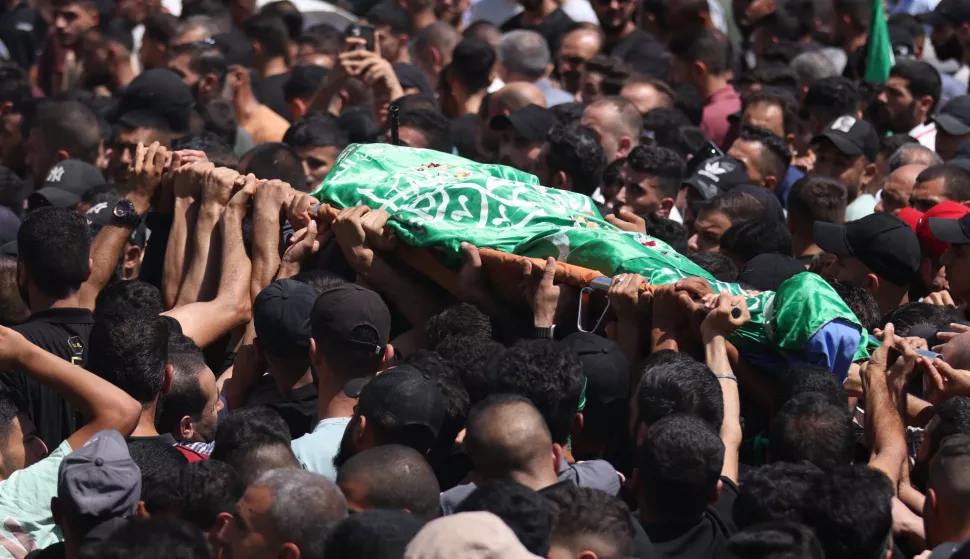 epa11554015 Mourners carry the body of Ahmad abu Ara, one of two Hamas militants who were killed on 17 August, during his funeral procession in the village of Aqaba, near the West Bank city of Tubas, 18 August 2024. The Israel Defence Forces (IDF) on 17 August confirmed the two Hamas militants were killed in an Israeli airstrike on a vehicle in Jenin, claiming they were linked to a shooting in the Jordan Valley that occurred on 11 August. EPA/ALAA BADARNEH