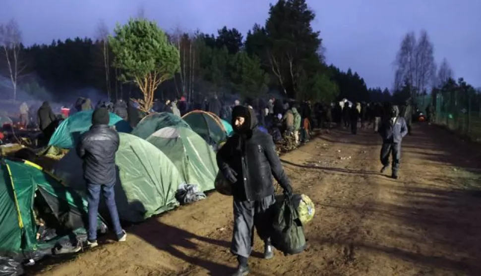 epa09588732 A handout photo made available by BelTA shows people at a camp at the Belarusian-Polish border near the Bruzgi-Kuznica Bialostocka border crossing, in the Grodno region, Belarus, 18 November 2021. Asylum-seekers, refugees and migrants from the Middle East arrived at the Belarusian-Polish checkpoint of Bruzgi-Kuznica aiming to cross the border. Thousands people who want to obtain asylum in the European Union have been trapped at low temperatures at the border since 08 November. EPA/MAXIM GUCHEK/BELTA HANDOUT -- MANDATORY CREDIT -- HANDOUT EDITORIAL USE ONLY/NO SALES