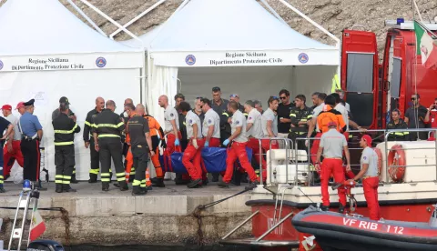 epa11558187 Rescue personnel carry another body of a passenger from Bayesian yacht after the recovery by fire brigade divers, in Porticello, near Palermo, Sicily Island, Italy, 21 August 2024. Search efforts continued on 21 August to find the six missing passengers of the Bayesian luxury sailboat that sank off Porticello near Palermo at dawn on 19 August. EPA/IGOR PETYX