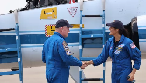 From left, NASA astronauts Butch Wilmore and Suni Williams, shake hands after arriving at Kennedy Space Center aboard T-38 aircraft, for the Starliner Crew Flight Test, on April 25, 2024. (Ricardo Ramirez Buxeda/Orlando Sentinel/TNS) Photo via Newscom Photo: Ricardo Ramirez Buxeda/NEWSCOM