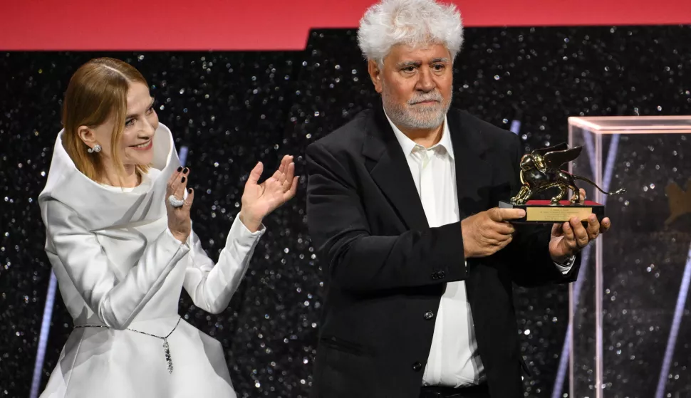 epa11591922 President of the Jury Venice 81, French actor Isabelle Huppert (L) applauds Spanish director and screenwriter Pedro Almodovar (R) as he holds the Golden Lion award for his movie 'The Room Next Door' during the closing ceremony of the 81st annual Venice International Film Festival, in Venice, Italy, 07 September 2024. EPA/ETTORE FERRARI