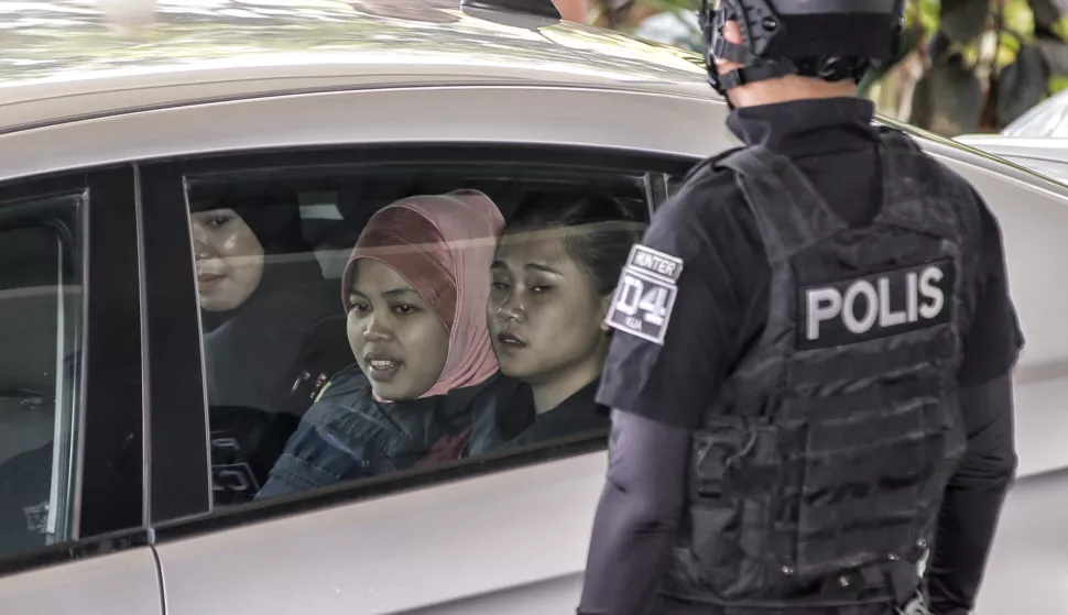 epa07238019 Siti Aisyah (2-L), who was detained in connection with the death of Kim Jong-Nam, is escorted by Malaysian police officers out of the Shah Alam High Court, in Shah Alam, Malaysia, 18 December 2018. Doan Thi Huong from Vietnam and Siti Aisyah from Indonesia, charged with murder under Section 302 of the penal code, which carries mandatory death sentence if found guilty, pleaded not guilty during the murder trial. The duo is charged with the murder of Kim Jong-Nam, the eldest son of former North Korean leader Kim Jong-il. EPA/AHMAD YUSNI