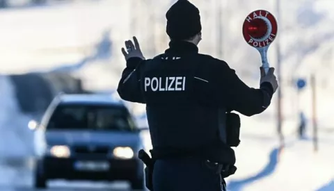 epa09011283 A member of the German Federal Police stops a car at the border crossing in Zinnwald, on the Germany-Czech Republic border, 14 February 2021. Germany reinstated temporary entry bans and border controls from Czech Republic due to growing numbers of coronavirus variant cases in the Czech country. Starting from 14 February, stricter entry rules apply to the German border with the Czech Republic and the Austrian state of Tyrol. EPA/FILIP SINGER