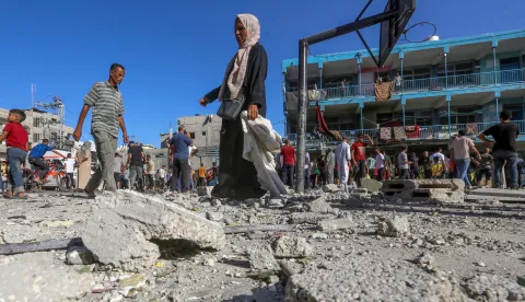 epa11599111 Palestinians inspect the rubble of a destroyed UNRWA-run school, a school-turned-shelter known as al-Jaouni, following an Israeli air strike in Al-Nuseirat refugee camp, central Gaza Strip, 11 September 2024. According to the Palestinian Ministry of Health in Gaza, at least 18 Palestinians have been killed and dozens injured following Israeli air strikes. The Israeli military stated that it conducted a 'precise strike' on militants operating inside a Hamas command and control center in the area of Nuseirat in central Gaza. More than 40,000 Palestinians and over 1,400 Israelis have been killed, according to the Palestinian Health Ministry and the Israel Defense Forces (IDF), since Hamas militants launched an attack against Israel from the Gaza Strip on 07 October 2023, and the Israeli operations in Gaza and the West Bank which followed it. EPA/MOHAMMED SABER