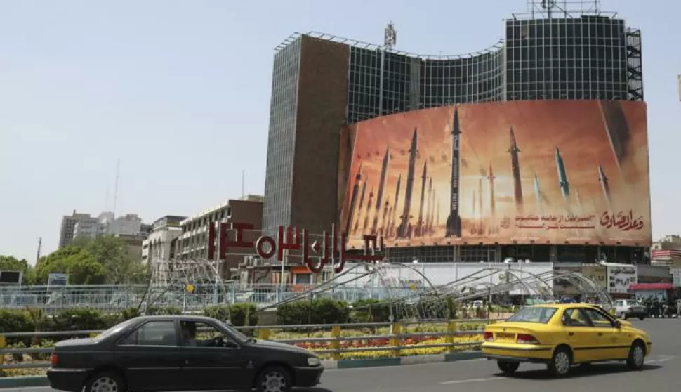 epa11279808 Iranians drive past an anti-Israel billboard carrying pictures of Iranian missiles in Tehran, Iran, 15 April 2024. Iran's Islamic Revolutionary Guards Corps (IRGC) launched drones and rockets towards Israel late on 13 April 2024, Iranian officials said. EPA/ABEDIN TAHERKENAREH