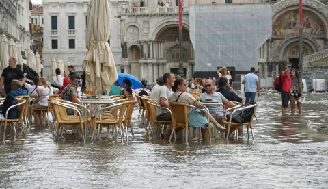 epa11587227 People are seated at a cafe after floods affected St. Mark's Square, Venice, Italy, 05 September 2024. Northern Italy was pounded by torrential rain and flooding. EPA/ANDREA MEROLA