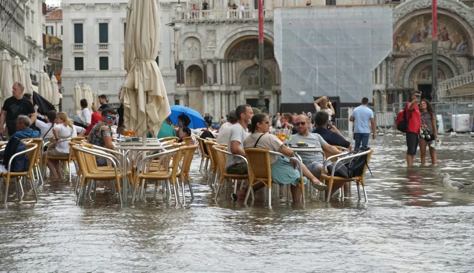 epa11587227 People are seated at a cafe after floods affected St. Mark's Square, Venice, Italy, 05 September 2024. Northern Italy was pounded by torrential rain and flooding. EPA/ANDREA MEROLA