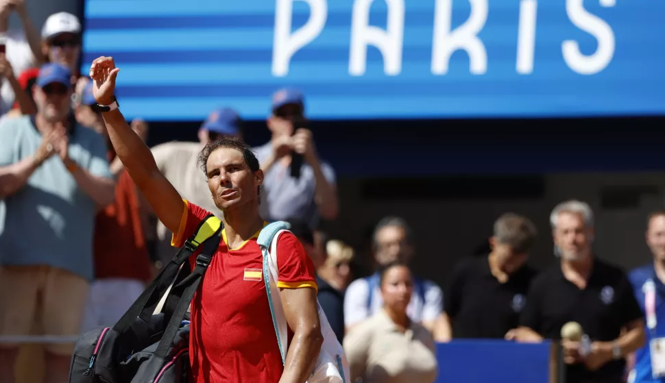 epa11505841 Rafael Nadal of Spain waves to the spectators after losing the Men's Singles second round match against Novak Djokovic of Serbia at the Tennis competitions in the Paris 2024 Olympic Games, at the Roland Garros in Paris, France, 29 July 2024. EPA/FRANCK ROBICHON