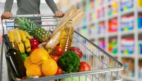 Woman buying in the supermarket with a shopping cart