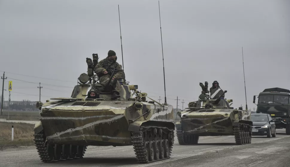 epa09784384 Russian soldiers on the amphibious infantry fighting vehicle BMP-2 move towards mainland Ukraine on the road near Armiansk, Crimea, 25 February 2022. Russian troops entered Ukraine on 24 February prompting the country's president to declare martial law and triggering a series of announcements by Western countries to impose severe economic sanctions on Russia. EPA/STRINGER