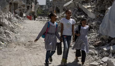 epa11599975 Palestinian children walk past destroyed buildings as they head to class in the Khan Younis camp, southern Gaza Strip, 12 September 2024. Palestinian teacher Israa Abu Mustafa (not pictured) set up a makeshift classroom in a tent built on the rubble of her old house. According to a statement released by the Palestinian Ministry of Education, more than 650,000 students in the Gaza Strip are being deprived of their right to education for the second academic year in a row. At least 84 percent of schools in the Gaza Strip 'require full reconstruction or significant rehabilitation before schooling can resume', the United Nations Children's Fund (UNICEF) reported in September 2024. More than 41,000 Palestinians and over 1,400 Israelis have been killed, according to the Palestinian Health Ministry and the Israel Defense Forces (IDF), since Hamas militants launched an attack against Israel from the Gaza Strip on 07 October 2023, and the Israeli operations in Gaza and the West Bank which followed it. EPA/HAITHAM IMAD