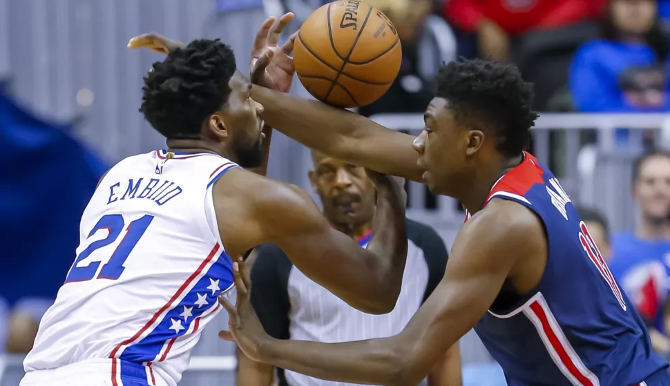 epa07272253 Philadelphia 76ers center Joel Embiid of Cameroon (L) in action against Washington Wizards center Thomas Bryant (R) during the first half of the NBA basketball game between the Philadelphia 76ers and the Washington Wizards at CapitalOne Arena in Washington, DC, USA, 09 January 2019. EPA/ERIK S. LESSER SHUTTERSTOCK OUT