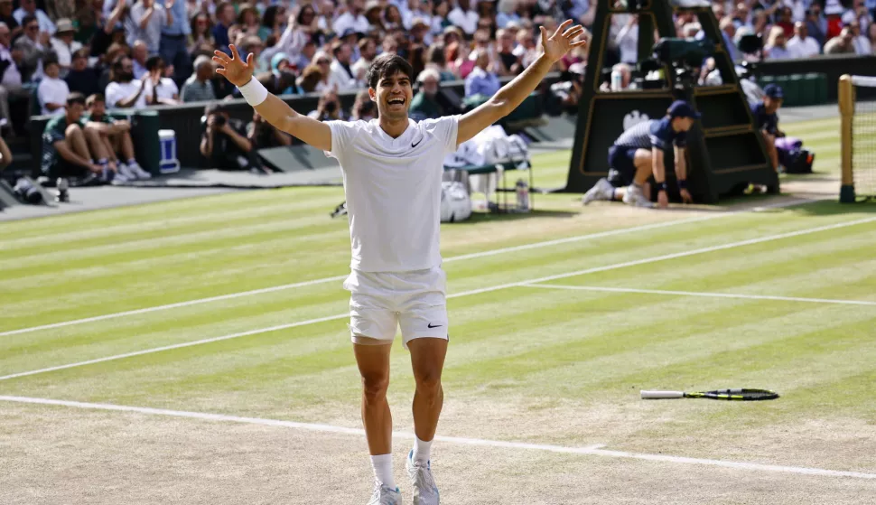 epa11477770 Carlos Alcaraz of Spain celebrates after winning the men's singles final against Novak Djokovic of Serbia at the Wimbledon Championships, Wimbledon, Britain, 14 July 2024. EPA/TOLGA AKMEN EDITORIAL USE ONLY