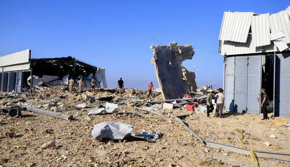 epa11623385 People inspect the area near by a damaged building after Israeli raids in Jiyeh, South Lebanon on 25 September2024. According to Lebanon's Ministry of Health, at least 558 people have been killed, and more than 1,835 have been injured following continued Israeli airstrikes on southern Lebanese towns and villages. More than 41,300 Palestinians and over 1,400 Israelis have been killed, according to the Palestinian Health Ministry and the Israel Defense Forces (IDF), since Hamas militants launched an attack against Israel from the Gaza Strip on 07 October 2023, and the Israeli operations in Gaza and the West Bank which followed it. EPA/STR