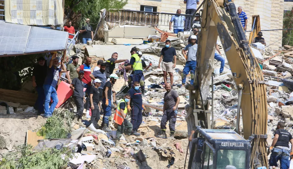 epa11633525 Search and rescue team members, together with locals, work to find bodies under the rubble of buildings destroyed in an Israeli airstrike the previous day in Ain el-Delb neighborhood, east of the port city of Sidon, southern Lebanon, 30 September 2024. According to the UN Humanitarian Coordinator in Lebanon, Imran Riza, the recent escalations in Lebanon have led to widespread destruction of homes and infrastructure across the country. At least 700 people have been killed, thousands have been injured, and nearly 120,000 people have been displaced in the past week.