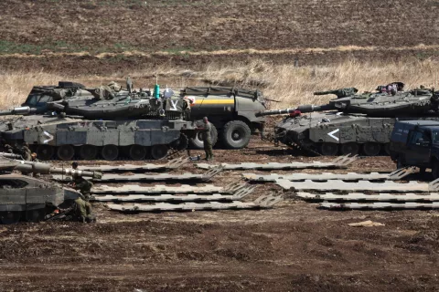 epa11633431 Israeli military vehicles at a gathering site next to the border with Lebanon as seen from an undisclosed location in northern Israel, 30 September 2024. The Israeli military announced on 30 September that it had eliminated the head of the Lebanon Branch of Hamas during an 'overnight joining IDF and ISA intelligence-based' operation in Lebanon.