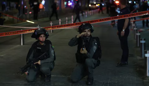 epa11636168 Armed Israeli police officers keep watch near a cordon at the site of a shooting incident in Tel Aviv, Israel, 01 October 2024. According to Israeli police, at least eight people were killed and nine others wounded in a shooting incident on Sderot Yerushalim in Tel Aviv. Two gunmen have been 'neutralized' on site, police said. EPA/ABIR SULTAN