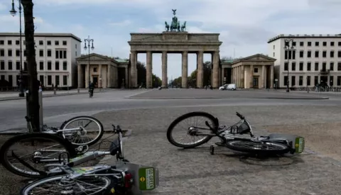 epa08364337 A view of fallen rental bicycles near the Brandenburg Gate in the empty Pariser Platz in Berlin, Germany, 15 April 2020. The popular tourist attraction site stands almost empty from visitors these days. The German government and local authorities are heightening measures to stem the spread of the coronavirus SARS-CoV-2 which causes the COVID-19 disease. The so called 'social distancing' restrictions should remain in effect until 19 April. EPA/FILIP SINGER