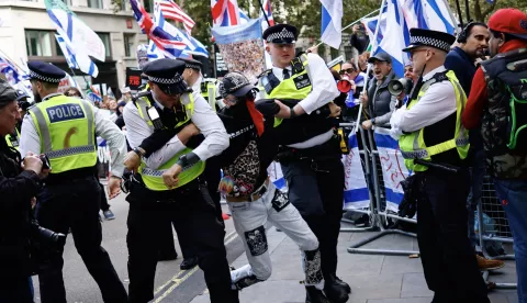 epa11643355 Police officers detain a demonstrator during a march to Downing Street to mark one year of the Israeli operations in the Gaza Strip and to call for a permanent ceasefire as part of an event organised by the Palestine Solidarity Campaign in London, Britain, 05 October 2024. Upcoming 07 October 2024, marks one year since the Palestinian militant group Hamas launched a surprise attack on Israel, killing 1,200, and one year since Israel began its war on Gaza, killing more than 41,000 and destroying the Palestinian enclave. EPA/TOLGA AKMEN