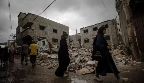 epa11635336 Palestinians walk past a destroyed house following an Israeli air strike in Al Nusairat refugee camp, central Gaza Strip, 01 October 2024. More than 41,000 Palestinians and over 1,400 Israelis have been killed, according to the Palestinian Health Ministry and the Israel Defense Forces (IDF), since Hamas militants launched an attack against Israel from the Gaza Strip on 07 October 2023, and the Israeli operations in Gaza and the West Bank which followed it. EPA/MOHAMMED SABER