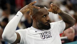 epaselect epa11531903 LeBron James of the US makes a crown gesture during the men's quarterfinal match between Brazil and USA in the Basketball competitions in the Paris 2024 Olympic Games, at the South Paris Arena in Paris, France, 06 August 2024. EPA/CAROLINE BREHMAN