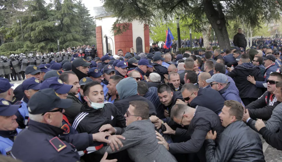 epa07468760 Supporters of the opposition clash with the police line outside the parliament building during a protest in Tirana, Albania, 28 March 2019. The opposition and its supporters are calling for the government to step down and for early elections to be held. They accuse Prime Minister Edi Rama's regime of corruption and link to organized crime. EPA/MALTON DIBRA