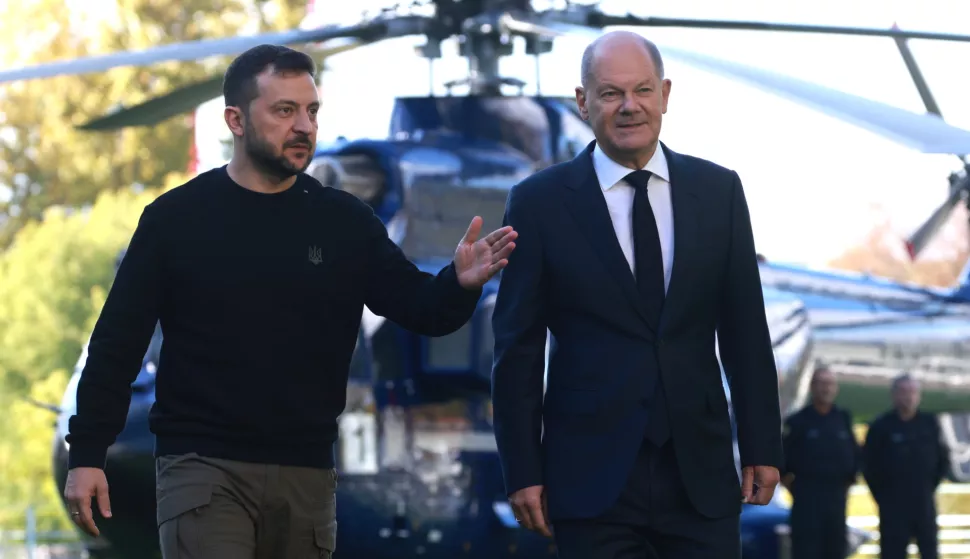 epa11654642 German Chancellor Olaf Scholz (R) and Ukrainian President Volodymyr Zelensky (L) walk in front of a helicopter at the chancellery in Berlin, Germany, 11 October 2024. Zelensky is on a visit to Germany after visiting France and Italy. EPA/CLEMENS BILAN