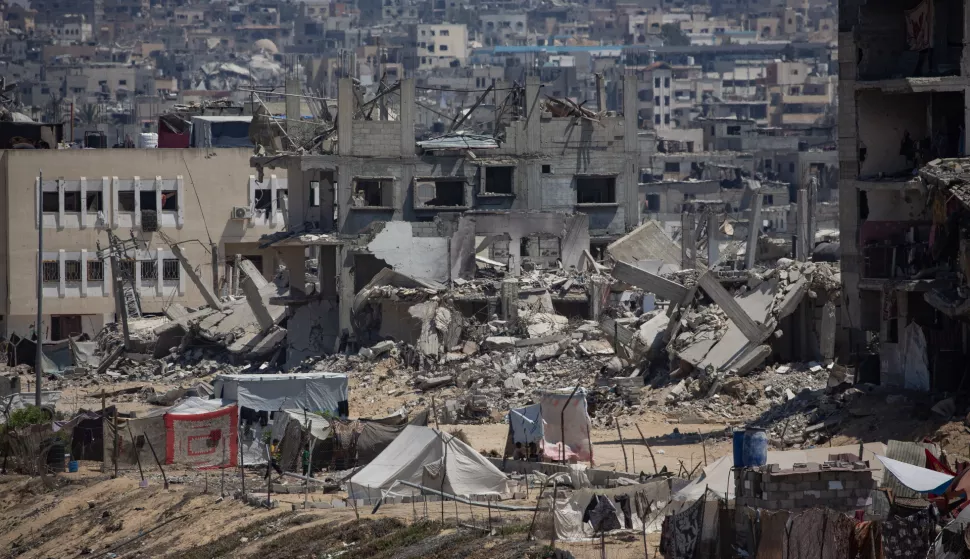 epa11515541 Displaced Palestinians set up their tents next to sewage and a garbage dump on a street in Khan Younis camp in the southern Gaza Strip, 01 August 2024. Since 07 October 2023, up to 1.7 million people, or more than 75 percent of the population, have been displaced throughout the Gaza Strip, some more than once, in search of safety, according to the United Nations Relief and Works Agency for Palestine Refugees in the Near East (UNRWA), which added that the Palestinian enclave is 'on the brink of famine', with 1.1 million people (half of its population) 'experiencing catastrophic food insecurity' due to the conflict and restrictions on humanitarian access. EPA/HAITHAM IMAD