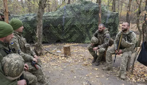 epa11651159 Servicemen of the newly formed 154th Separate Mechanized Brigade rest before moving to a combat position on a frontline in the Kharkiv region, northeastern Ukraine, 09 October 2024, amid the ongoing Russian invasion. Russian troops entered Ukrainian territory on 24 February 2022, starting a conflict that has provoked destruction and a humanitarian crisis. EPA/SERGEY KOZLOV