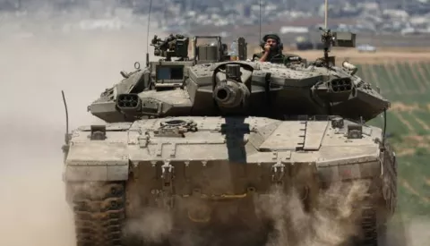 epa11344328 Israeli tanks patroll near the security fence with Jabalia in the northern part of the Gaza Strip, in the background, southern Israel, 16 May 2024. More than 35,100 Palestinians and over 1,455 Israelis have been killed, according to the Palestinian Health Ministry and the Israel Defense Forces (IDF), since Hamas militants launched an attack against Israel from the Gaza Strip on 07 October 2023, and the Israeli operations in Gaza and the West Bank which followed it. EPA/ATEF SAFADI